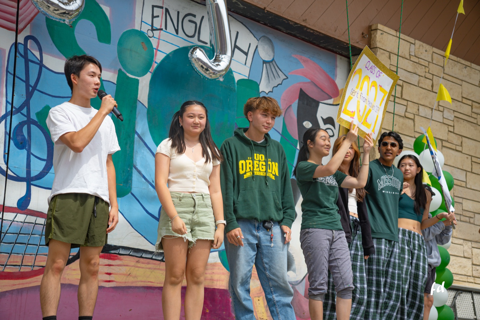 Sophomore class officers on the rally stage, Jadon on the mic