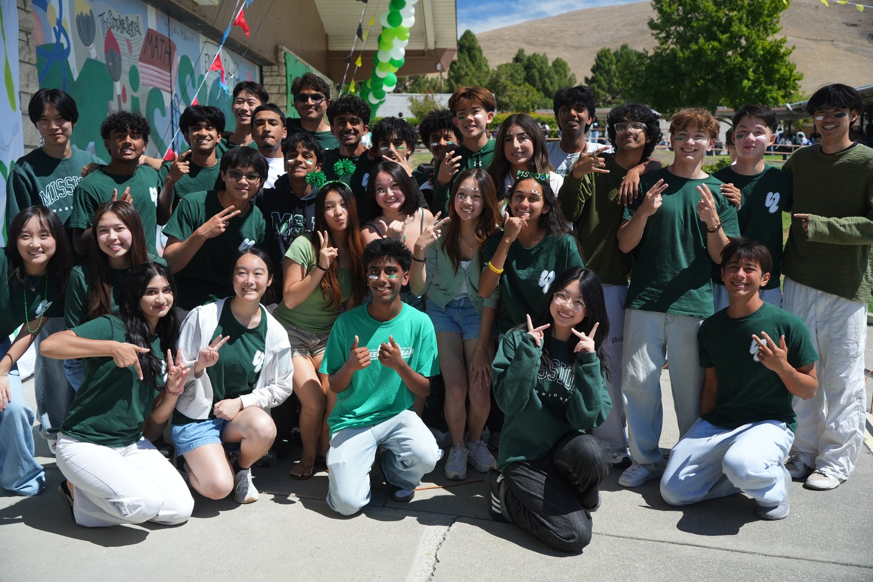 Leadership II 2026–2027 — the whole class in green at the Green & White Assembly