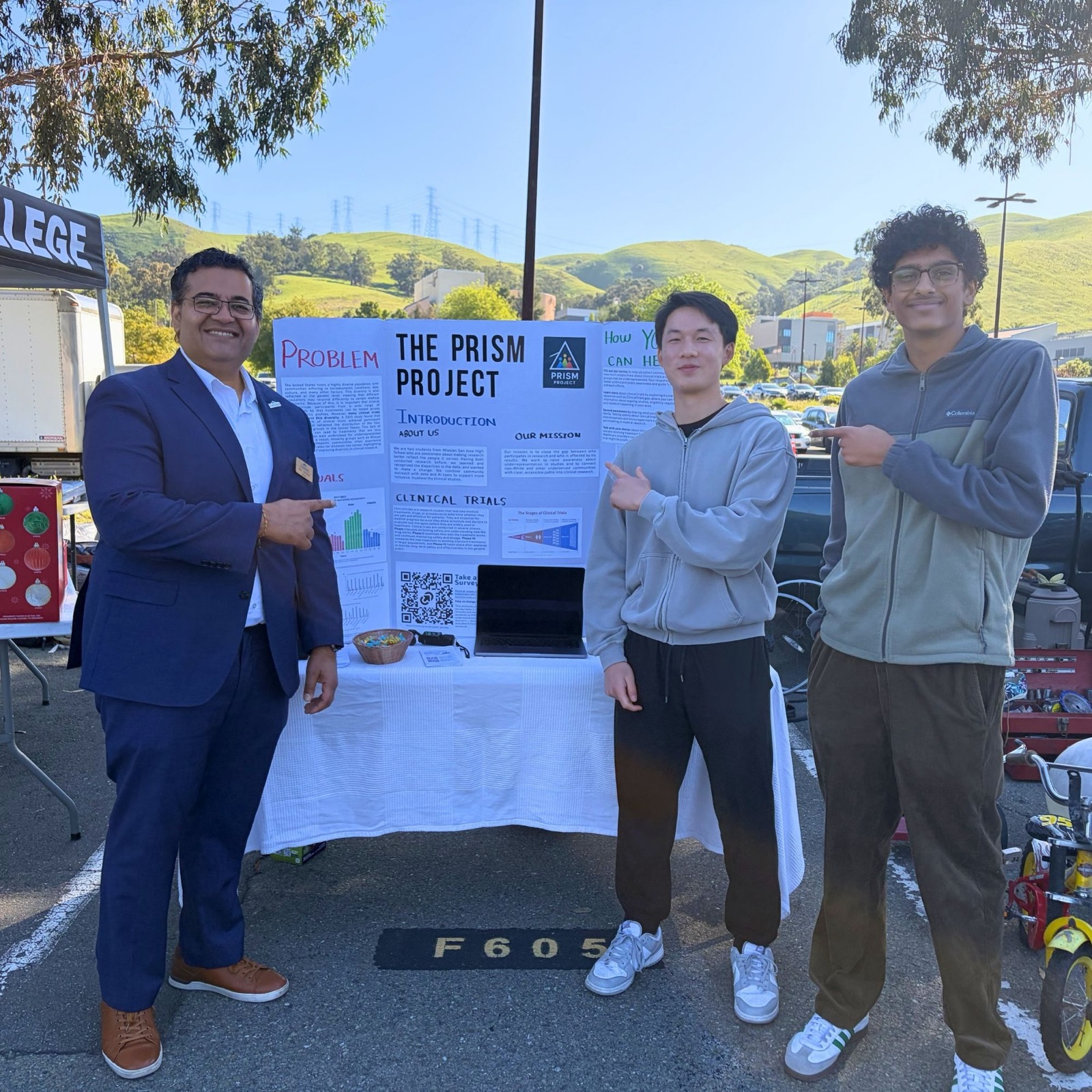 The PRISM Project board at a community event, with the mayor of Fremont and two student organisers