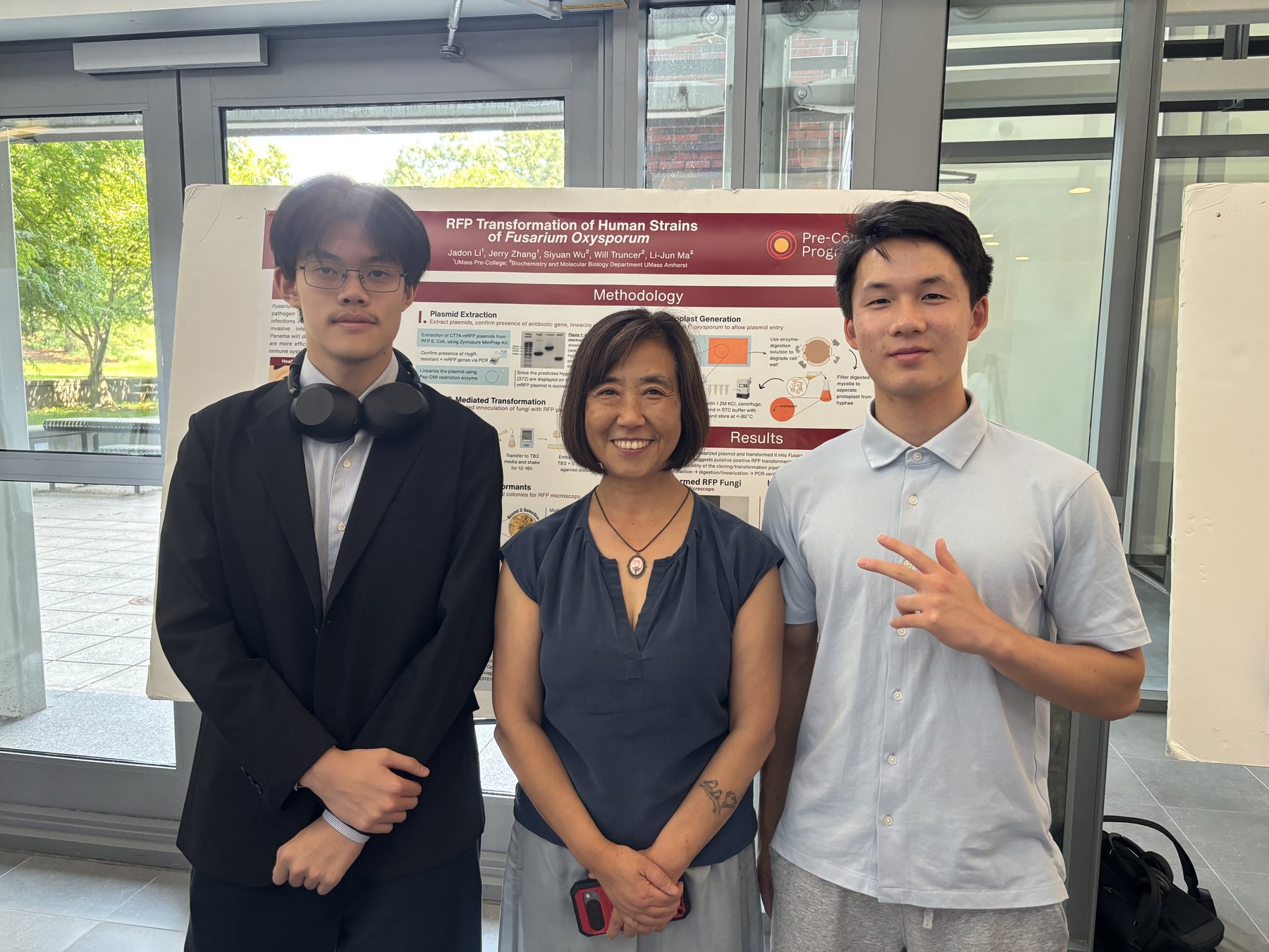 Jadon with the team in front of the Fusarium RFP poster at UMass Amherst