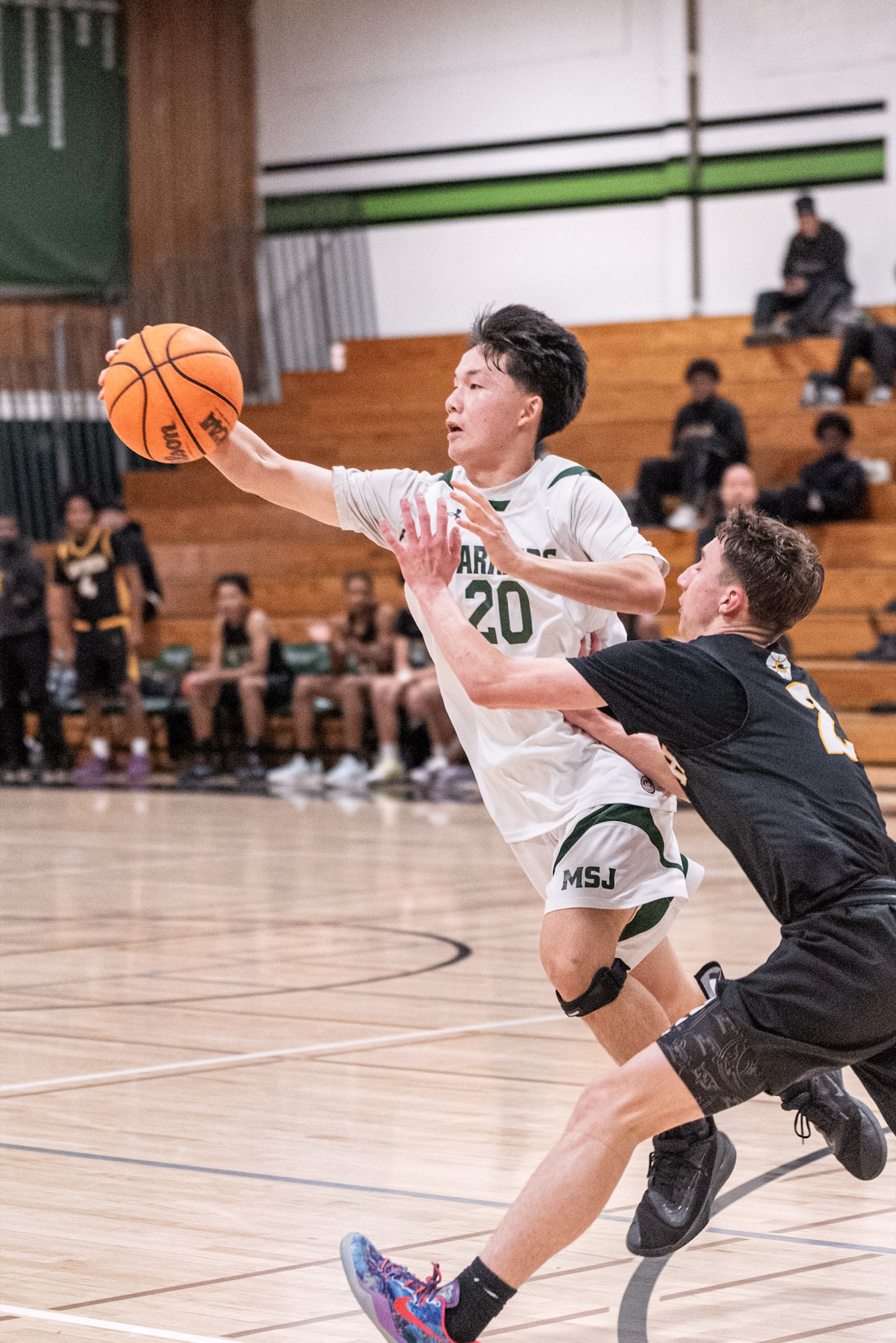 Jadon extending for a layup through contact in the NCS title season